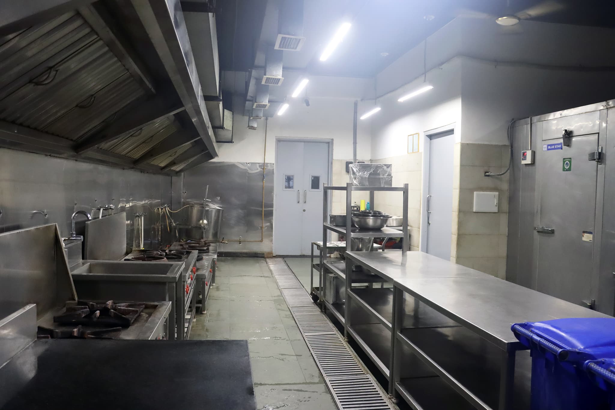 Modern central kitchen with stainless steel equipment